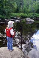 Anna, age 5, admiring the reflections in the pond at the portage between the Hegman Lakes, July 3, 2008