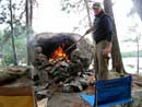 Clyde Tackett tending the fire at Wink Lake.