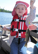 Granddaughter Anna, age 4, with her very first fish on Poplar Lake, 2007