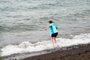 Granddaughter Anna looking for the perfect rock in Lake Superior surf at Naniboujou Lodge, August, 2017.